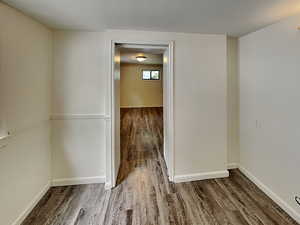 Empty room featuring wood finished floors and baseboards