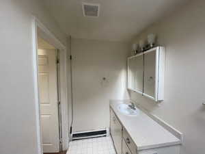 Bathroom featuring vanity, a baseboard radiator, and tile patterned floors