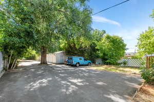 View of parking / parking lot featuring driveway