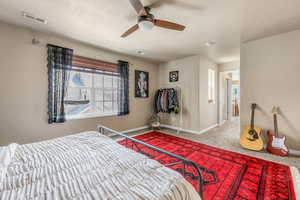 Bedroom with multiple windows, carpet, and ceiling fan
