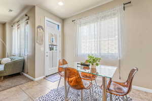 Dining space with baseboards and light tile patterned flooring