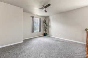 Empty room with carpet and ceiling fan