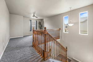 Corridor with an upstairs landing and carpet floors