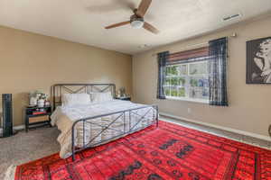 Carpeted bedroom with baseboards and ceiling fan