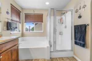 Bathroom with vanity, a shower stall, and a bath
