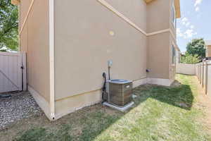 View of property exterior featuring stucco siding and a gate