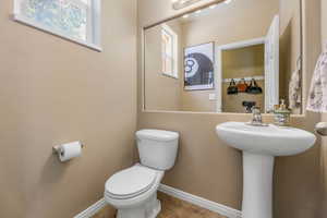 Half bathroom featuring toilet and baseboards