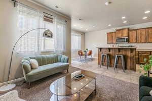 Living area with recessed lighting and light tile patterned flooring