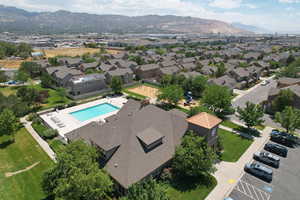 Aerial view of residential area featuring a mountainous background and a pool