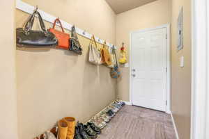Doorway featuring baseboards and tile patterned flooring