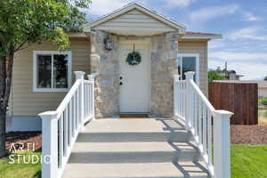 Property entrance featuring stone siding