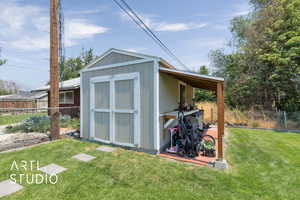 View of shed with a fenced backyard