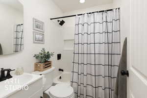 Bathroom featuring vanity and shower / bath combo with shower curtain