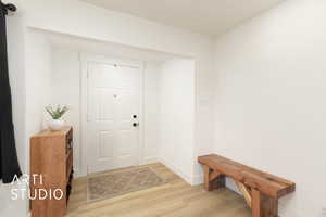 Entrance foyer with light wood-type flooring and baseboards