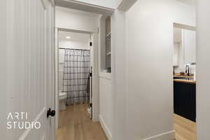 Hallway featuring light wood-style flooring