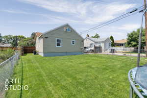 Rear view of property featuring a fenced backyard