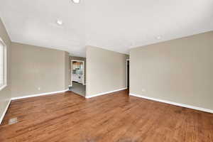 Empty room with baseboards and wood finished floors