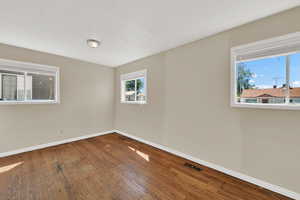Unfurnished room with baseboards and wood finished floors
