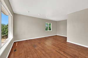 Unfurnished room featuring hardwood / wood-style floors and a textured ceiling