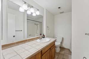 Bathroom with vanity and a shower with shower curtain