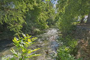 Water view with a heavily wooded area