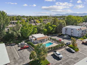 Aerial view of residential area with a pool and a mountain backdrop