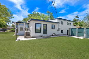 Back of property with a gate and crawl space