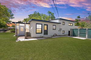 Rear view of property featuring a gate and crawl space