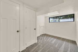 Unfurnished bedroom with carpet flooring, a textured ceiling, and recessed lighting