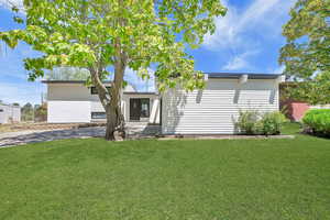 View of front of property with a front lawn