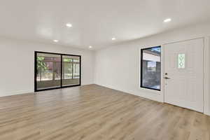 Entrance foyer featuring recessed lighting, healthy amount of natural light, and light wood-style flooring