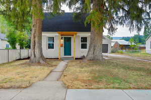 View of front of property featuring roof with shingles, brick siding, an attached garage, and concrete driveway