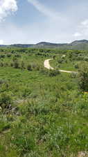 View of mountain backdrop featuring rural landscape