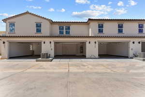 Mediterranean / spanish-style home with stucco siding, a garage, driveway, and a tile roof