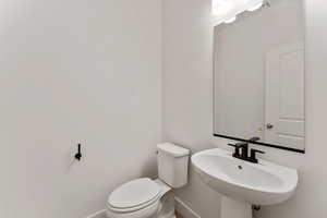 Bathroom with toilet and baseboards
