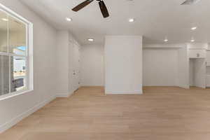 Empty room with light wood-style flooring, recessed lighting, a textured ceiling, and ceiling fan