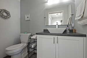 Half bathroom with toilet and vanity