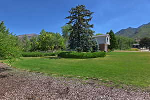 View of grassy yard featuring a mountain view