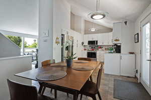 Dining space with high vaulted ceiling and a textured ceiling