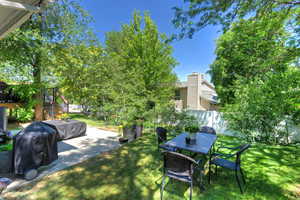 Fenced backyard with a patio area, stairs, and a deck