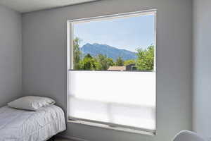Bedroom with a mountain view and a textured ceiling