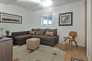 Living room featuring light wood-type flooring and baseboards