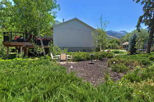 View of yard featuring a deck with mountain view