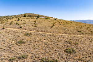 View of mountain backdrop featuring rural landscape
