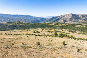 View of mountain backdrop with rural landscape