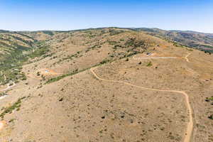 Aerial view of property's location featuring rural landscape and a mountainous background