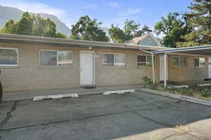View of front of house featuring brick siding, a mountain view, and uncovered parking