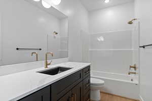 Bathroom featuring vanity, light wood-type flooring, and shower / bathtub combination