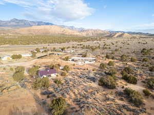 Aerial view of property's location with rural landscape and a mountain backdrop