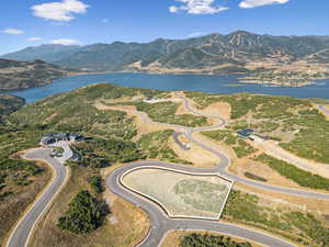 Aerial view of property's location featuring a water and mountain view